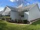 Exterior shot of home with well-maintained lawn, landscaping, and a gray roof at 2444 Merida Cir, The Villages, FL 32162