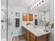 Bathroom featuring a glass shower, vanity with sink, and modern fixtures at 2444 Merida Cir, The Villages, FL 32162