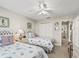 Bright bedroom featuring twin beds, coastal decor, ceiling fan, and access to en-suite bathroom at 2444 Merida Cir, The Villages, FL 32162