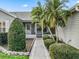 Close up of a well maintained front entrance, with tidy landscaping and neutral siding at 2444 Merida Cir, The Villages, FL 32162