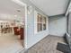 Enclosed lanai featuring tile flooring and outdoor window shutters, offering a relaxing transition from the indoors at 2444 Merida Cir, The Villages, FL 32162