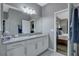 Bright bathroom featuring granite countertops, white cabinets, and an open doorway to the main bedroom at 245 Citrus Pointe Dr, Haines City, FL 33844