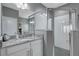 Well-lit bathroom features granite countertops, stylish lighting, and a glass-enclosed shower at 245 Citrus Pointe Dr, Haines City, FL 33844