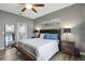 Spacious bedroom featuring a large bed, modern decor, wood floors, and an ensuite bathroom at 245 Citrus Pointe Dr, Haines City, FL 33844