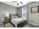 Bedroom featuring neutral tones, with a ceiling fan, luxury vinyl plank flooring, and a window for natural light at 245 Citrus Pointe Dr, Haines City, FL 33844