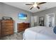 Cozy bedroom showcasing neutral tones, wood floors, and a door to an ensuite bathroom at 245 Citrus Pointe Dr, Haines City, FL 33844