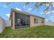 Exterior view of the home showcasing the screened patio with an outdoor seating area at 245 Citrus Pointe Dr, Haines City, FL 33844