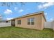 Rear exterior view showing the home's design and the screened-in patio with access to the backyard at 245 Citrus Pointe Dr, Haines City, FL 33844