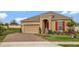 Single-story home with a brick driveway, two-car garage and a well-manicured front lawn at 245 Citrus Pointe Dr, Haines City, FL 33844