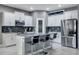 Contemporary kitchen with white cabinetry, an island with seating, and stainless steel appliances at 245 Citrus Pointe Dr, Haines City, FL 33844