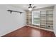 Bedroom with built-in shelving and wooden floors, featuring lots of natural light at 24548 Calusa Blvd, Eustis, FL 32736