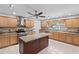 Well-lit kitchen featuring granite countertops, center island, and stainless steel appliances at 24548 Calusa Blvd, Eustis, FL 32736