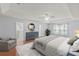 Bedroom with a king-size bed, wood floors, neutral walls, and bright, natural lighting at 24548 Calusa Blvd, Eustis, FL 32736