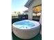 A tranquil hot tub with a view of the green yard at 255 Matisse Ave, The Villages, FL 32162