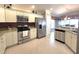 Modern kitchen featuring stainless steel appliances, granite countertops, and white cabinetry at 255 Matisse Ave, The Villages, FL 32162