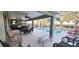 Covered patio featuring outdoor kitchen and a screened pool area at 255 Matisse Ave, The Villages, FL 32162