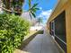 Backyard view of patio, sidewalk, grass, plants and landscaping, and the side of the home at 2668 Alandari Ln, The Villages, FL 32162