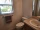 Bathroom featuring a toilet and a single sink vanity near a window at 2668 Alandari Ln, The Villages, FL 32162