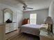 Bright bedroom with hardwood floors, ceiling fan, and white furniture at 2668 Alandari Ln, The Villages, FL 32162