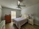 Bedroom with laminate wood floor, ceiling fan, and neutral walls at 2668 Alandari Ln, The Villages, FL 32162