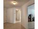 Bright hallway with tile floors leading to various rooms, offering a glimpse into the home's layout at 2668 Alandari Ln, The Villages, FL 32162