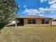 Exterior shot of the back of the home showing windows, siding, and the screened-in back porch at 2668 Alandari Ln, The Villages, FL 32162