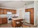 Bright kitchen with an island, wooden cabinets, a white refrigerator, and tile flooring at 2668 Alandari Ln, The Villages, FL 32162