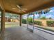 Relaxing screened-in patio features a ceiling fan and lovely view of the landscaped backyard at 2668 Alandari Ln, The Villages, FL 32162