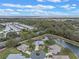 Aerial view of a community with a picturesque pond, showcasing the serene setting and nearby lake at 27710 Snow Orchid Ct, Leesburg, FL 34748