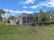 Picture of backyard with pool enclosure and manicured lawn at 27710 Snow Orchid Ct, Leesburg, FL 34748