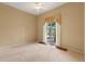 Bedroom featuring carpet, paint, and a sliding glass door at 27710 Snow Orchid Ct, Leesburg, FL 34748