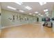 Bright and spacious dance studio with hardwood floors, mirrors, and ample room for community fitness activities at 27710 Snow Orchid Ct, Leesburg, FL 34748