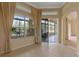 Bright living room featuring tile floors, large windows with curtains, and access to the sunroom at 27710 Snow Orchid Ct, Leesburg, FL 34748