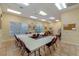 Large meeting room with neutral paint, tile floors, and bright fluorescent ceiling lights at 27710 Snow Orchid Ct, Leesburg, FL 34748