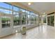 This sunroom features tile flooring, many windows and bright light at 27710 Snow Orchid Ct, Leesburg, FL 34748