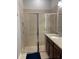 Bathroom featuring a glass-enclosed shower, granite countertop, and neutral tile at 294 Captiva Dr, Davenport, FL 33896