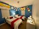 Comfortable bedroom with two twin beds, a bright blue design, and fun themed decorations at 294 Captiva Dr, Davenport, FL 33896