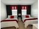The bedroom is designed with red and white accents, featuring fun mickey themed decor at 294 Captiva Dr, Davenport, FL 33896