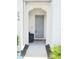 Inviting entryway with a gray front door, welcome mat, and neutral tones at 294 Captiva Dr, Davenport, FL 33896