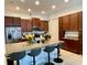 Open kitchen with granite countertops, stainless steel appliances, and bar seating for casual dining at 294 Captiva Dr, Davenport, FL 33896