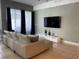 Bright living room with modern sofa, large television, and stylish decor for comfortable living at 294 Captiva Dr, Davenport, FL 33896