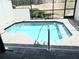 Inviting in-ground pool with brick patio in a screened enclosure at 294 Captiva Dr, Davenport, FL 33896