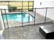 A private screened-in pool area with a safety fence and patio furniture at 294 Captiva Dr, Davenport, FL 33896