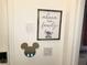 Charming wall decor with Disney-themed accents and modern security system keypad at 294 Captiva Dr, Davenport, FL 33896