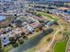 Aerial view of the house, community, surrounding lakes, and a nearby golf course at 305 Ranchwood Dr, Leesburg, FL 34748