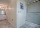 Hallway view of bathroom with tiled floors and shower with glass door at 305 Ranchwood Dr, Leesburg, FL 34748