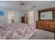 Bedroom with a large, decorative dresser and doorway access to kitchen and bathroom at 305 Ranchwood Dr, Leesburg, FL 34748