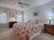 Bright bedroom features a ceiling fan, neutral paint and carpet, and decorative window treatments at 305 Ranchwood Dr, Leesburg, FL 34748