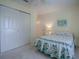 Bedroom features a ceiling fan, closet with sliding doors, and white walls at 305 Ranchwood Dr, Leesburg, FL 34748