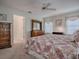 Comfortable bedroom with carpeted floor, dresser, and bright windows with natural light at 305 Ranchwood Dr, Leesburg, FL 34748